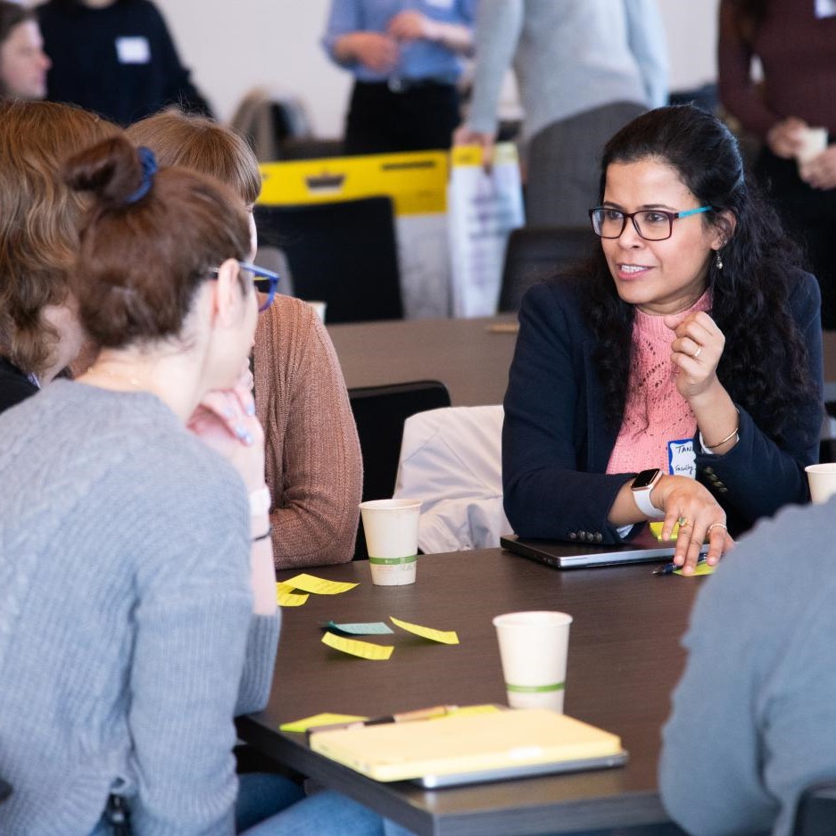Event attendees engage in a small-group discussion