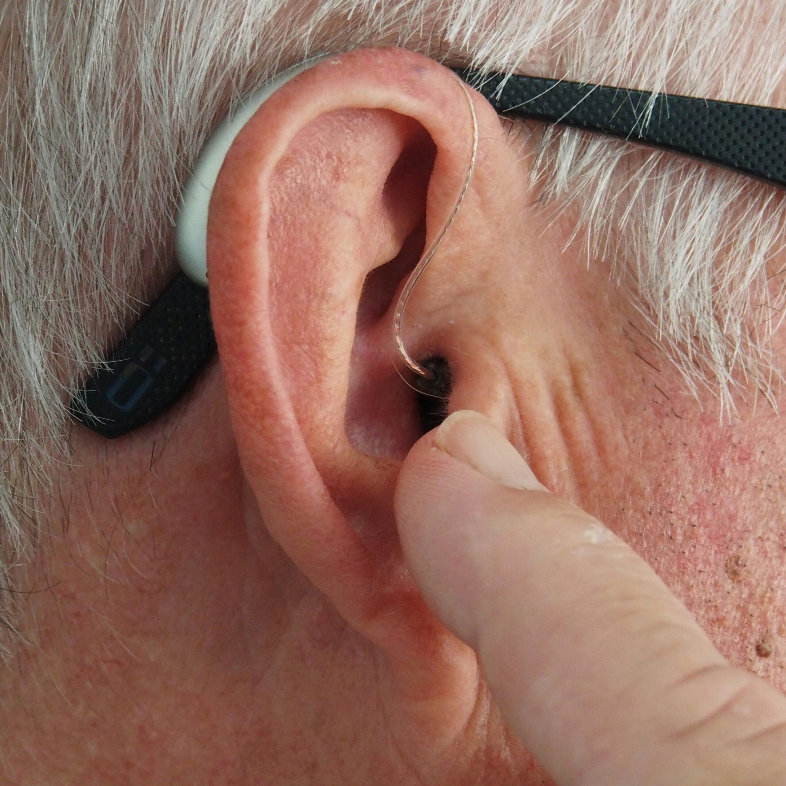 A hearing aid pictured in a man's ear