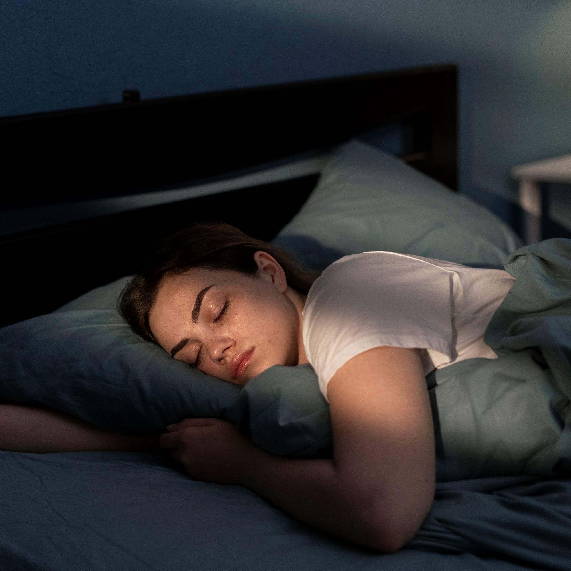 A woman sleeps peacefully in her bedroom at night