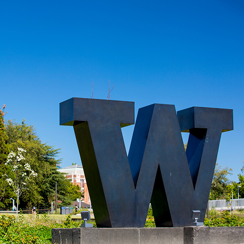 Image of a bronze UW at an entrance to the Seattle Campus